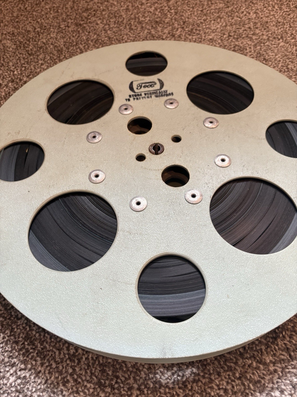VINTAGE – 15 INCH REWIND FILM REEL – WITH MYSTERY FILM STILL ON – USED