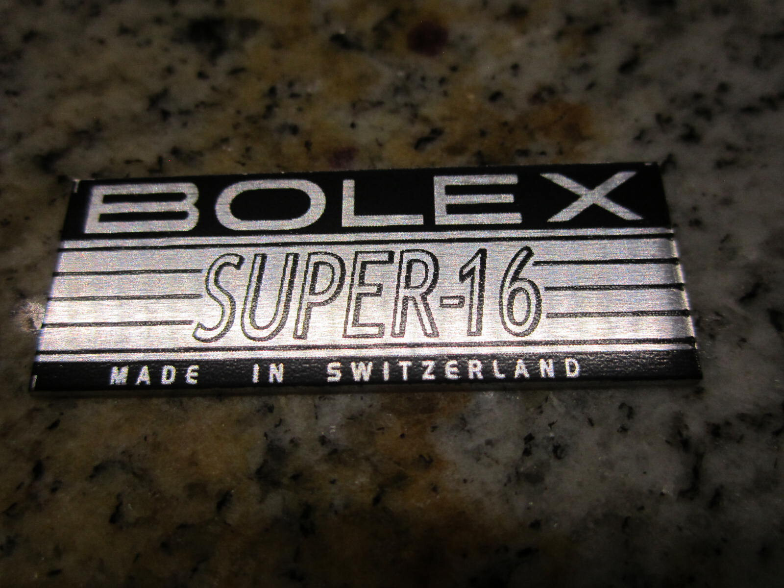BOLEX ‘SUPER-16′ LOGO PLATE BADGE’ (Glue-In) for BOLEX H16 16mm movie camera