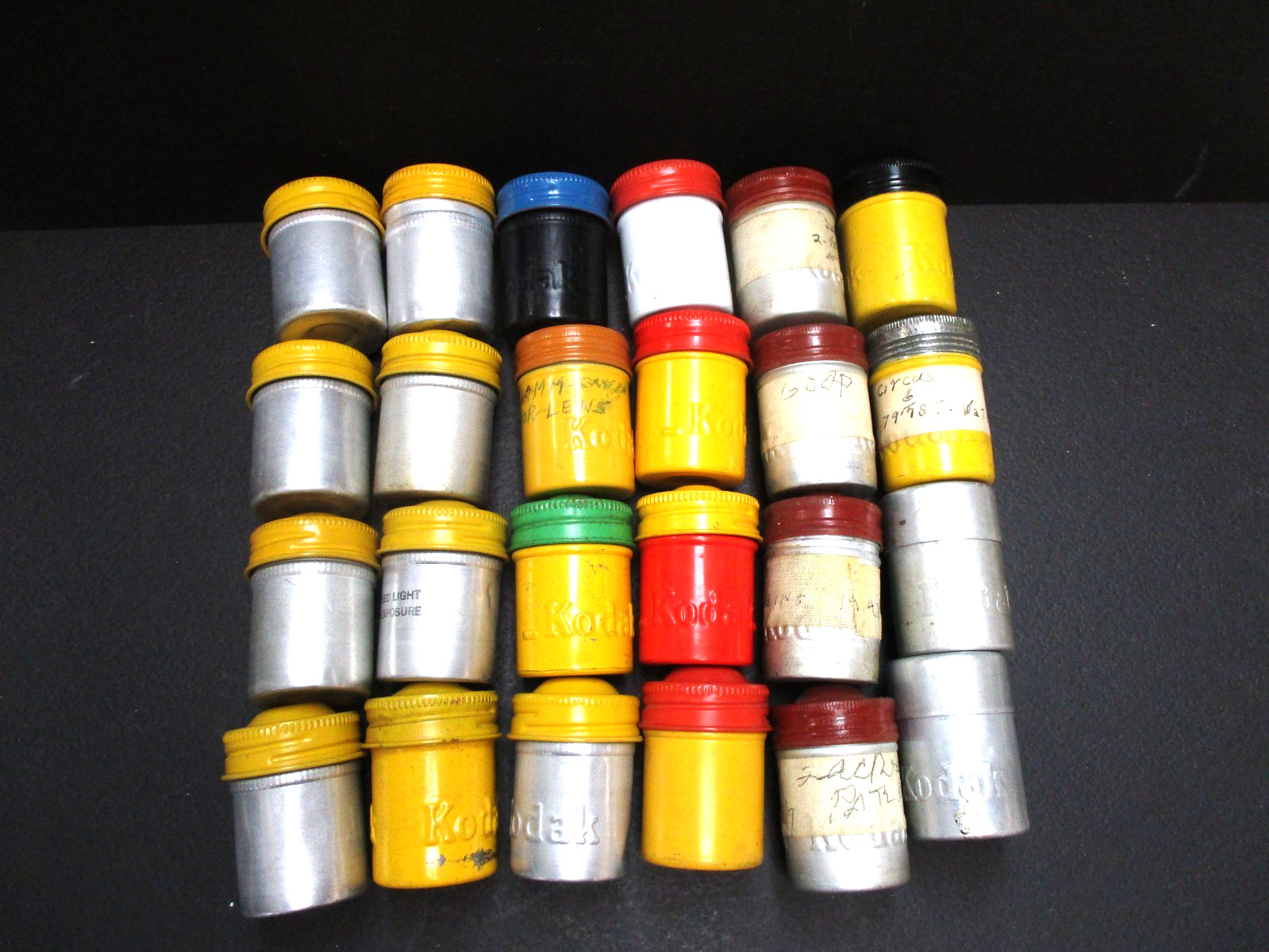 Lot 24 Kodak metal 35mm film canisters as shown.