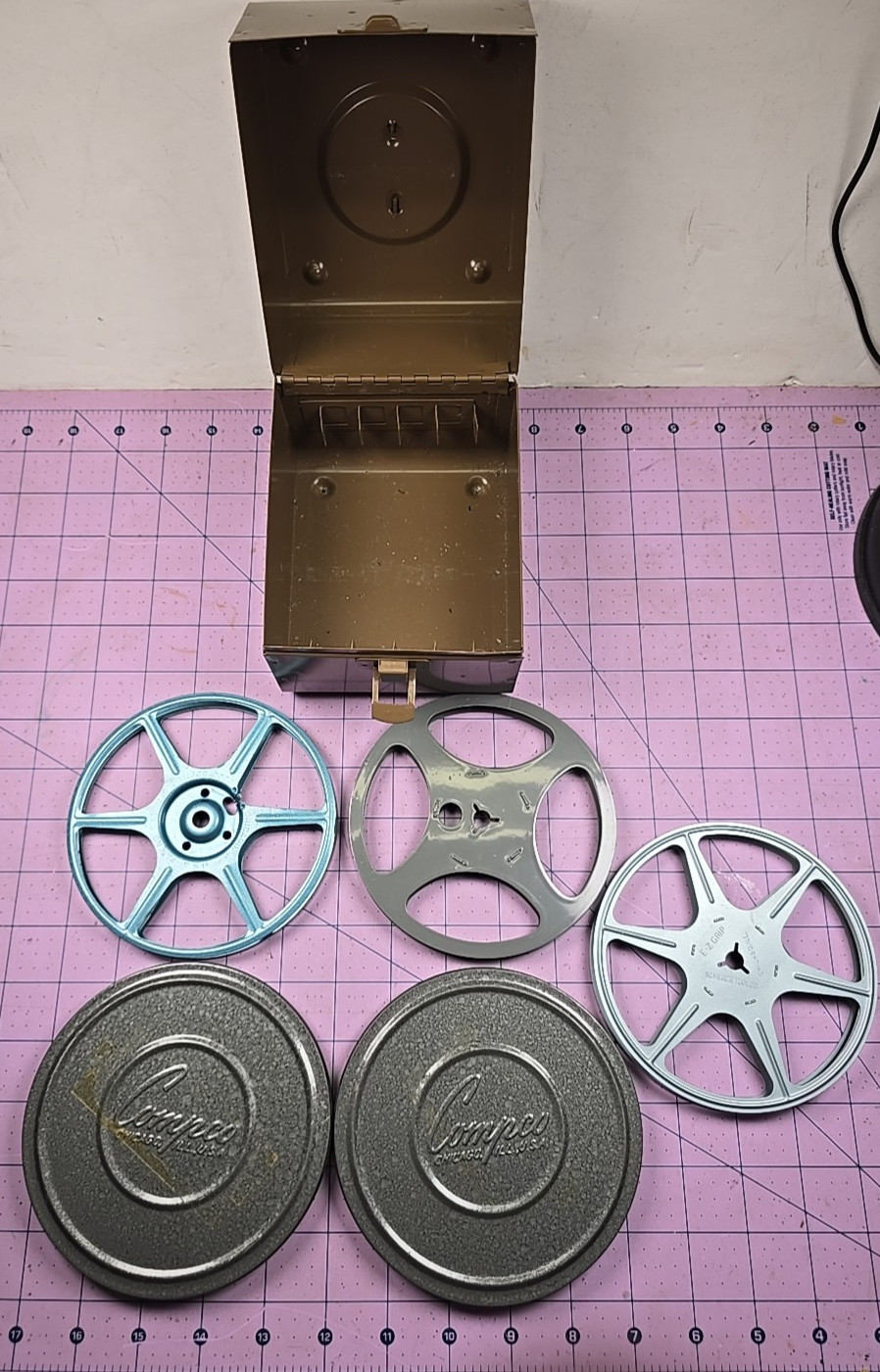 3 – 5″ 200Ft movie reels, 2 cans and carrying case – Comco and Scherer