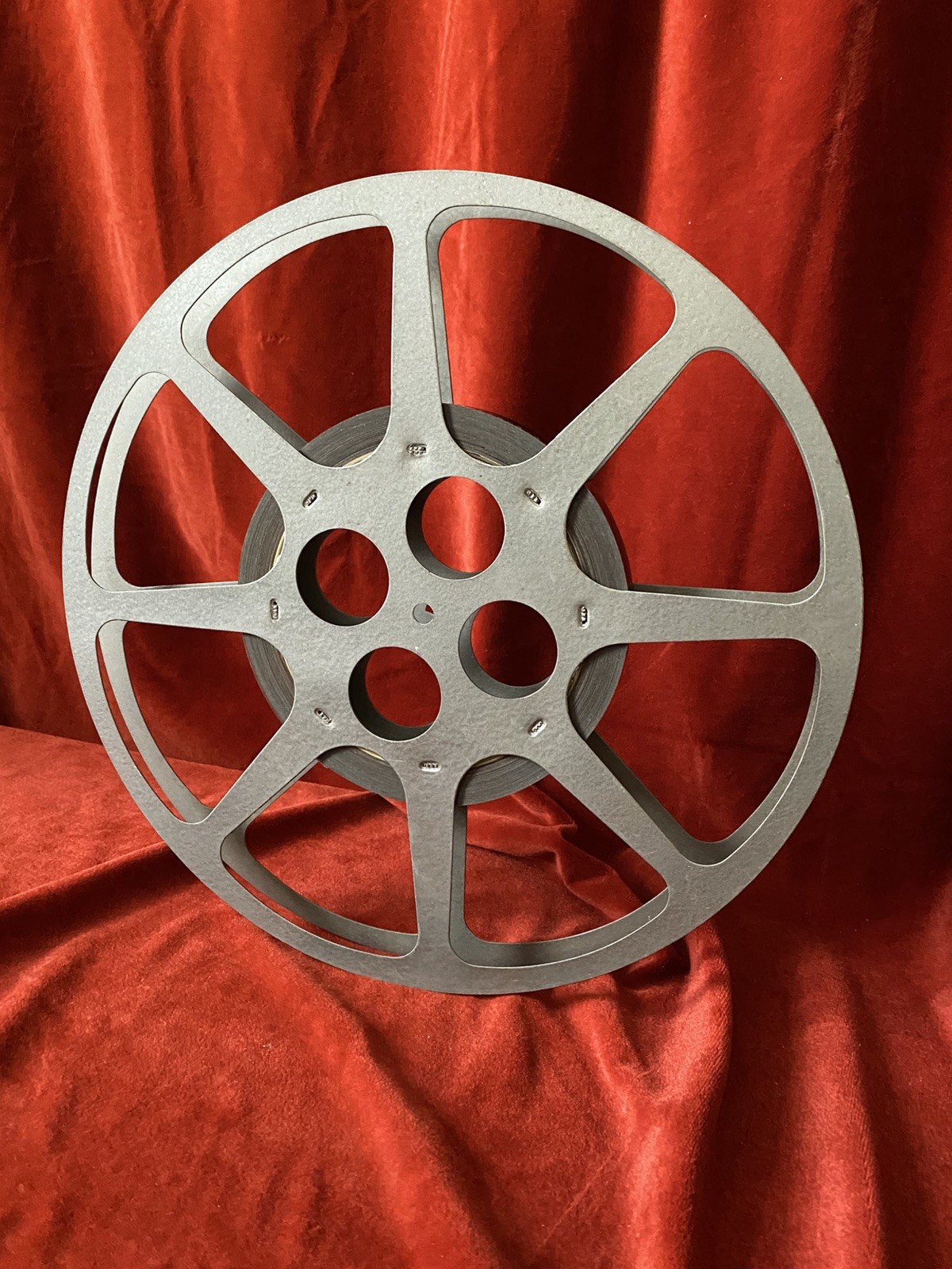 1200 ft Metal Moving Picture Reel 12 1/4” With a piece of an unknown film