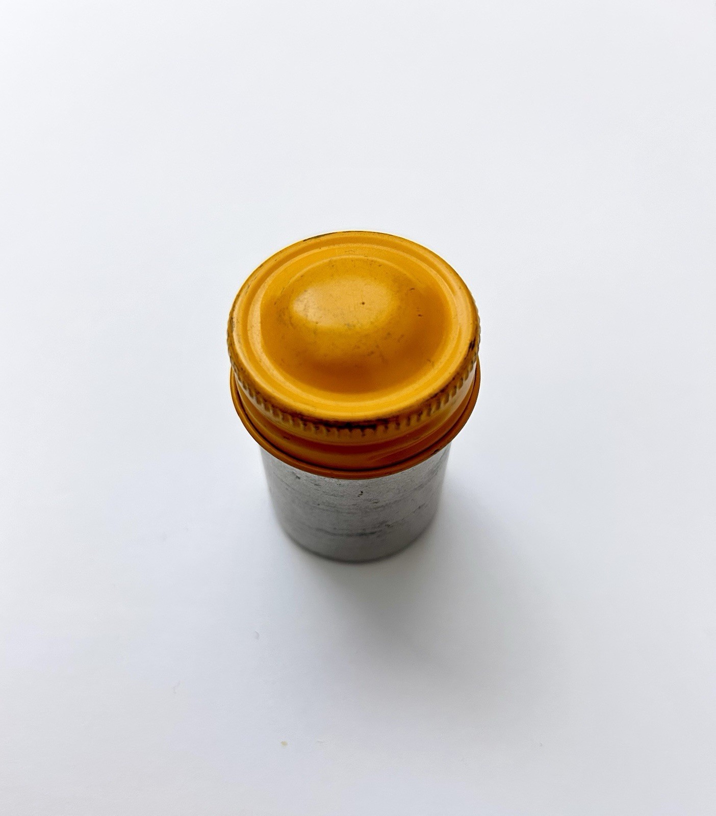 Classic Vintage 35mm aluminum film canister unbranded with metal yellow top cap