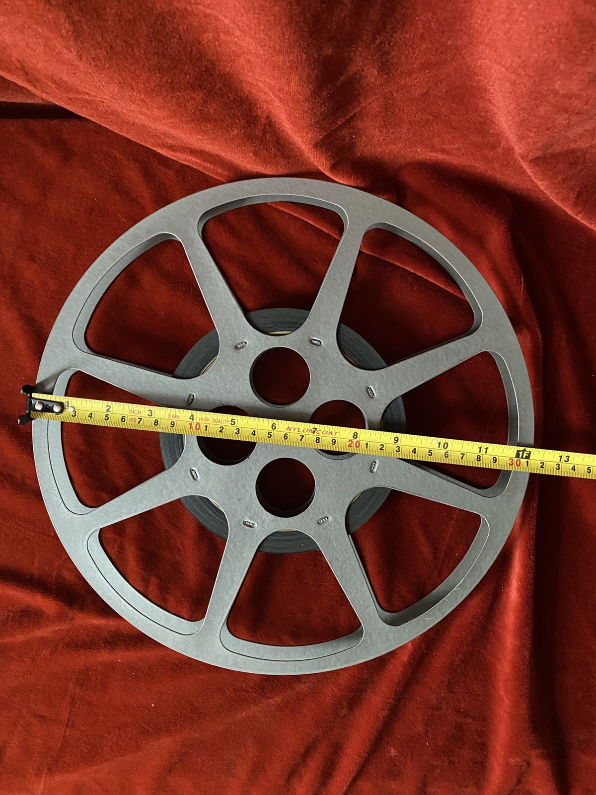 1200 ft Metal Moving Picture Reel 12 1/4” With a piece of an unknown film