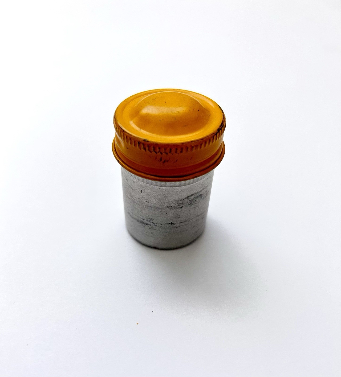 Classic Vintage 35mm aluminum film canister unbranded with metal yellow top cap