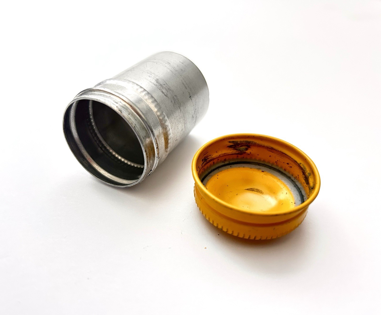 Classic Vintage 35mm aluminum film canister unbranded with metal yellow top cap