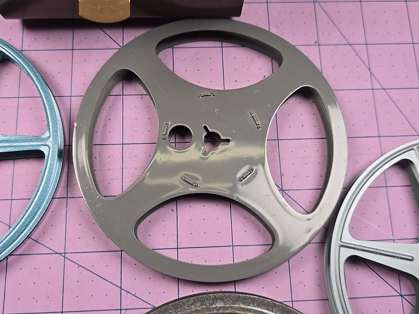 3 – 5″ 200Ft movie reels, 2 cans and carrying case – Comco and Scherer