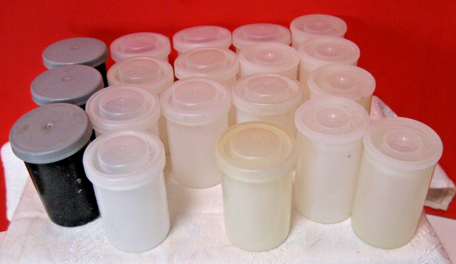 19 Film Cannisters; Five tall white, 12 shorter white, three grey.