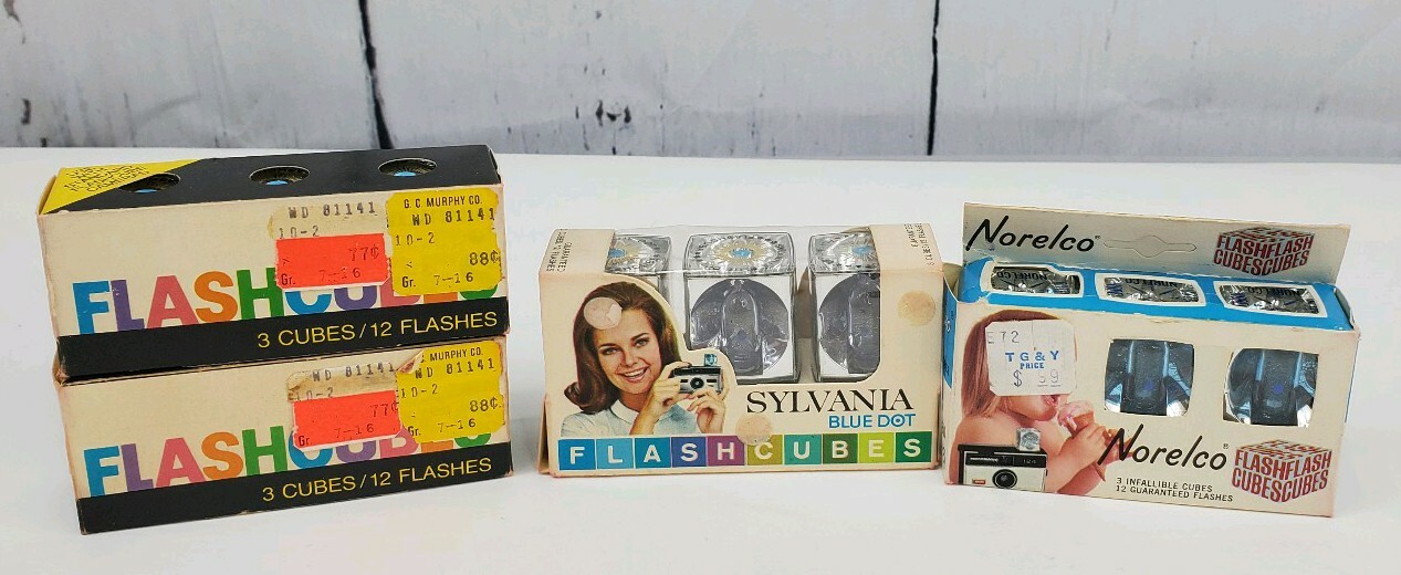 4 Camera Flash Cubes, 3 Boxes of Sylvania Blue Dot, 1 Box of Norelco NOS Bulbs