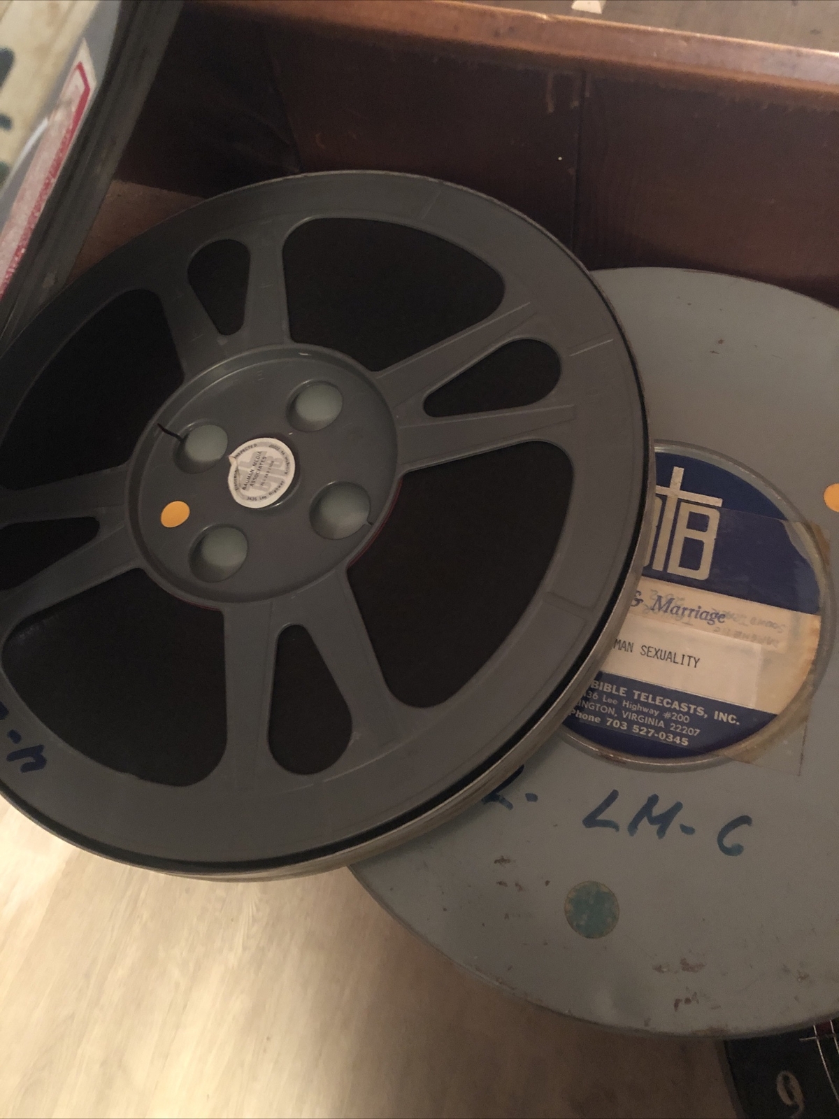 Two Gray Movie Reels In Canister