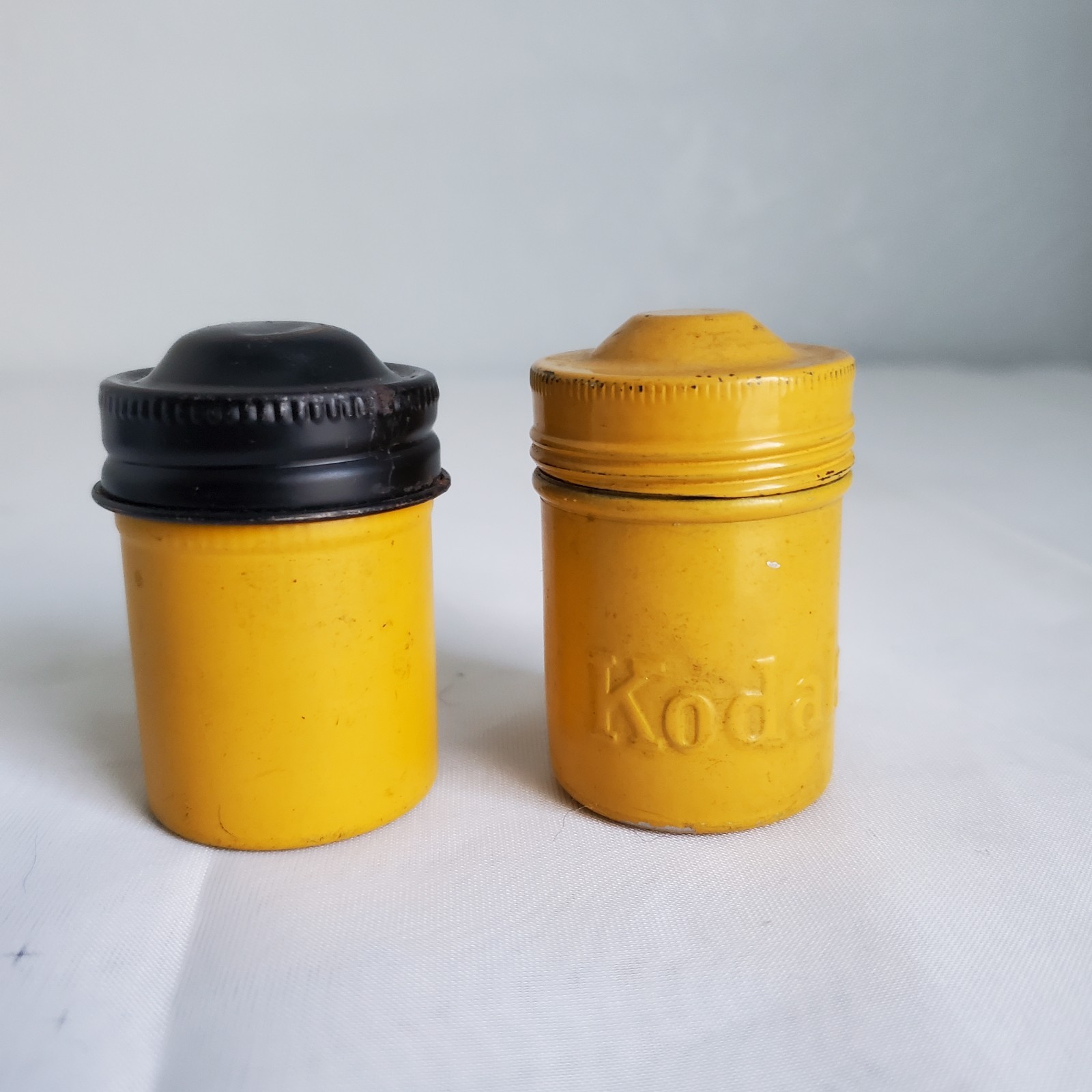 Lot of 2 Kodak Black Yellow Embossed Metal Film Roll Containers