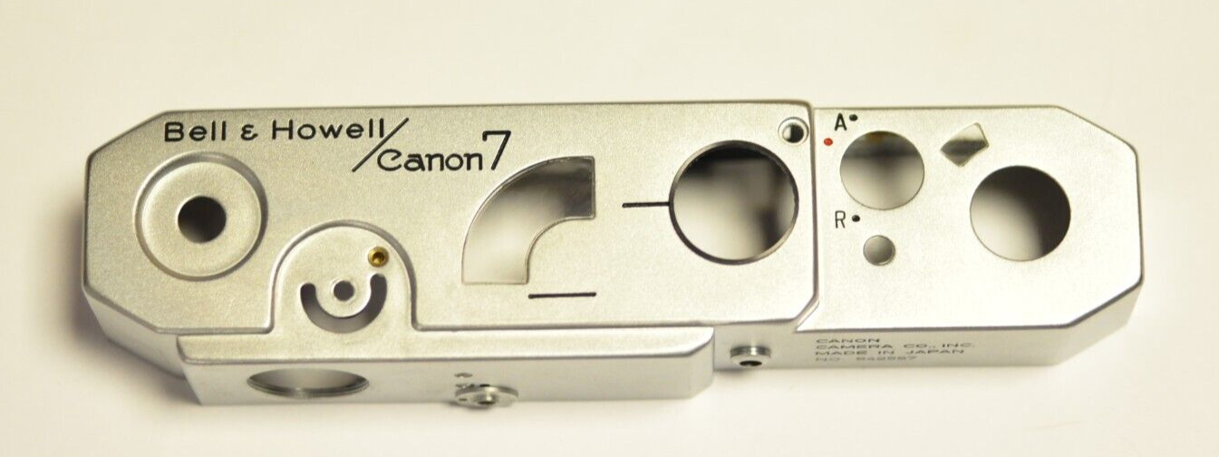 Bell & Howell/Canon model 7 35mm rfdr. silver repl. top cover. Nos. READ. I