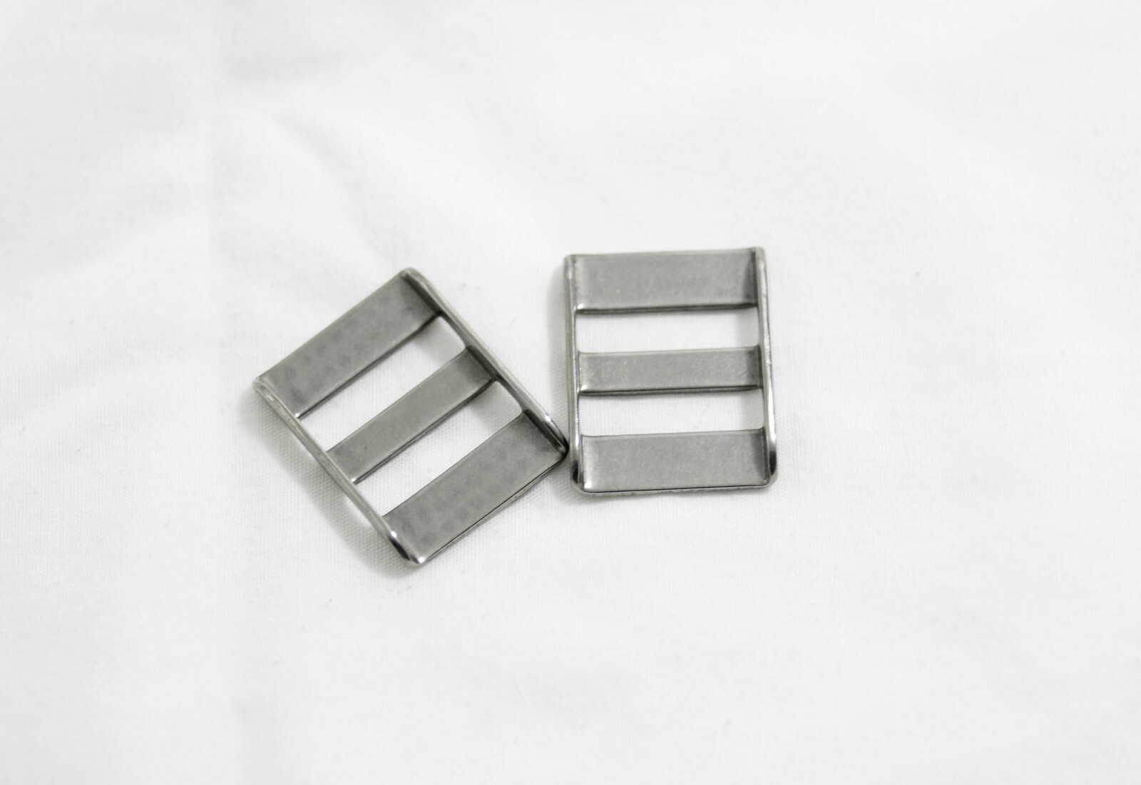 VINTAGE PAIR OF NIKON 3/4 INCH METAL CAMERA STRAP HOLDERS