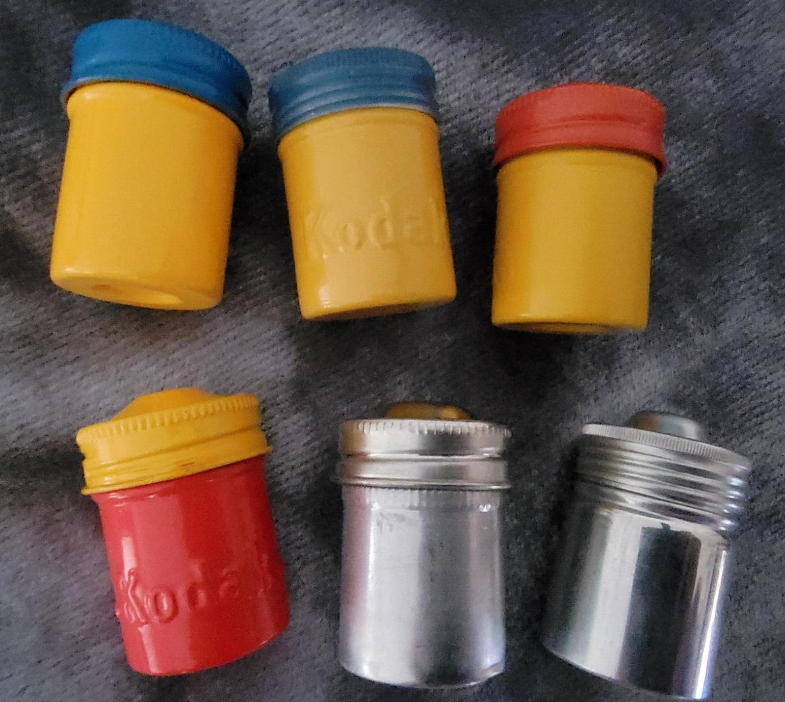 Vintage 35 mm film canisters-leather, metal and paper