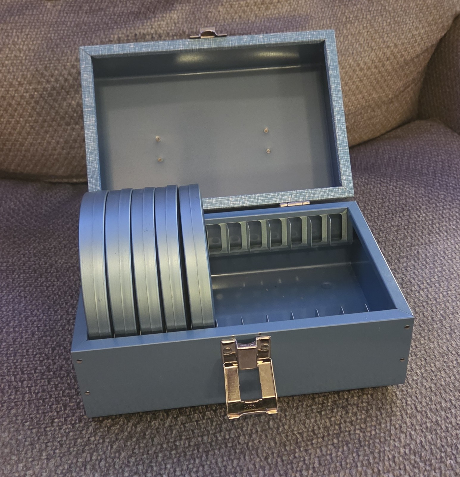 Five (5) Dual 8 Movie Reels with Metal Cans and Metal Storage Box – 5″ diameter