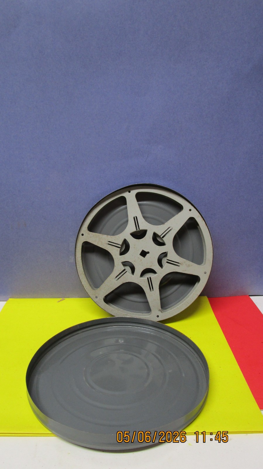 empty 7 inch tin film canister with reel