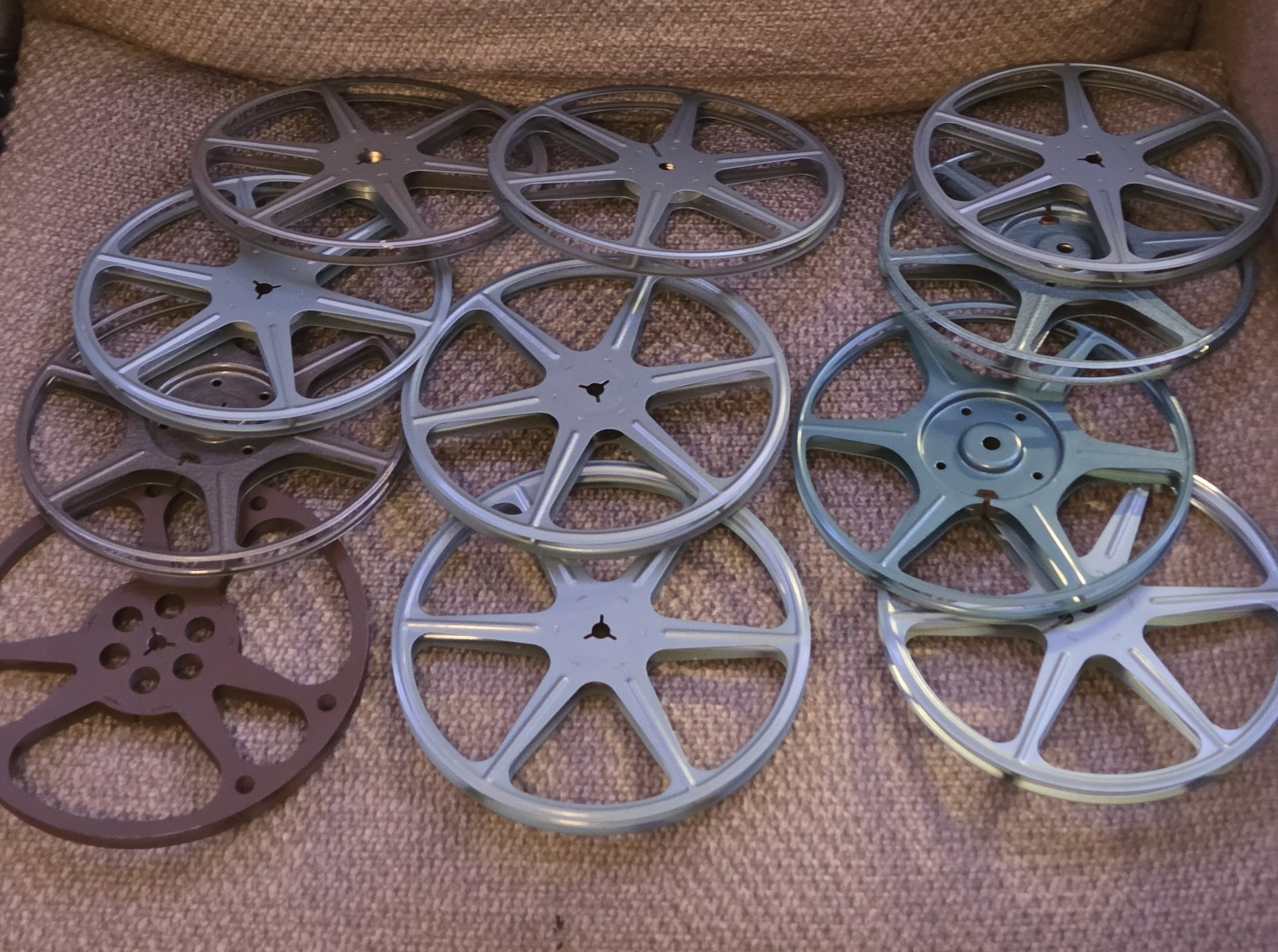 Eleven (11) 7″ Diameter Movie Reels with Metal Cans and Carrying Case