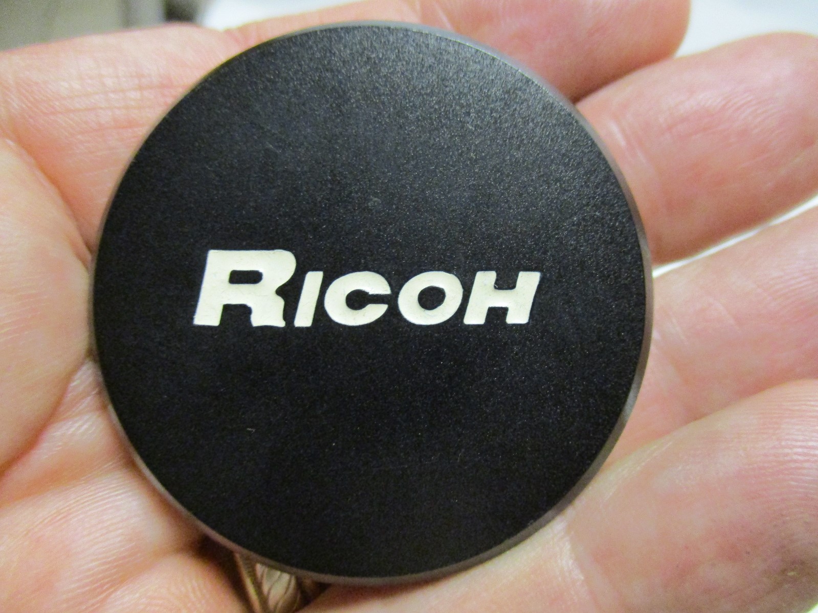 Ricoh black metal push on lens cap. Looks to be inside dia. of 43mm.