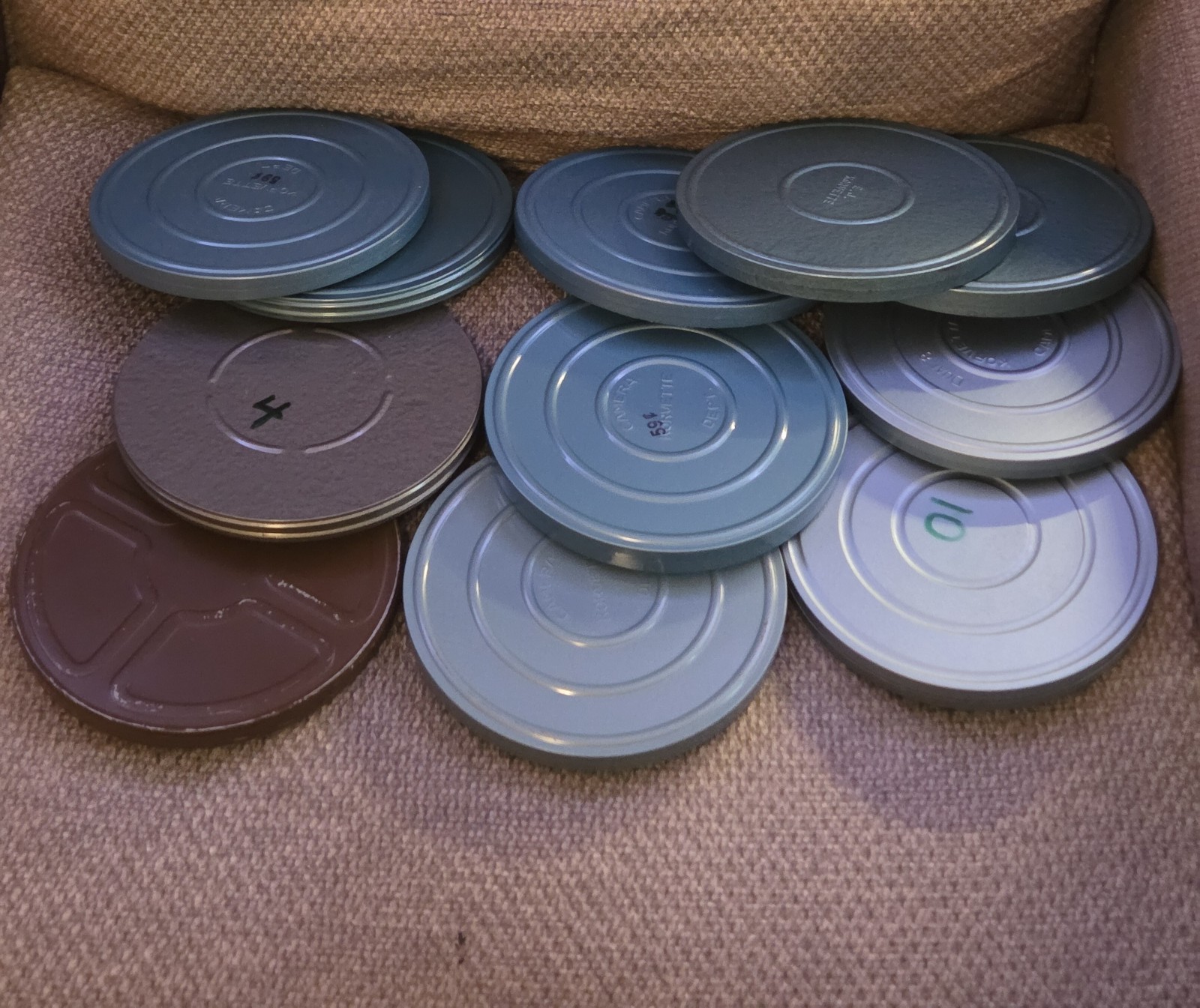 Eleven (11) 7″ Diameter Movie Reels with Metal Cans and Carrying Case