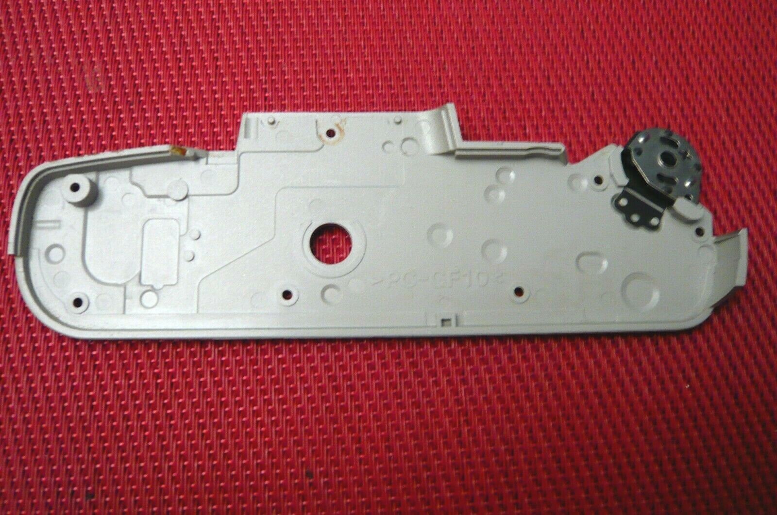 Bottom plate with battery door for Pentax ZX 10 camera.