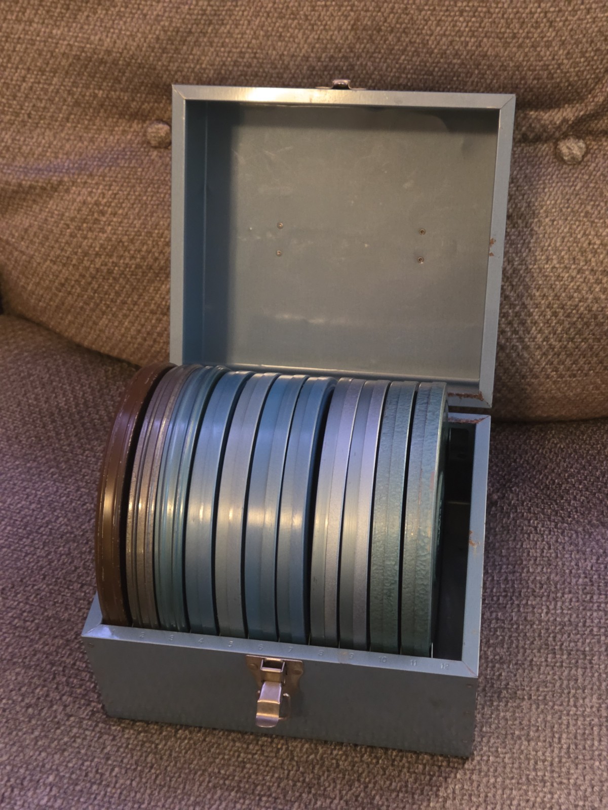 Eleven (11) 7″ Diameter Movie Reels with Metal Cans and Carrying Case