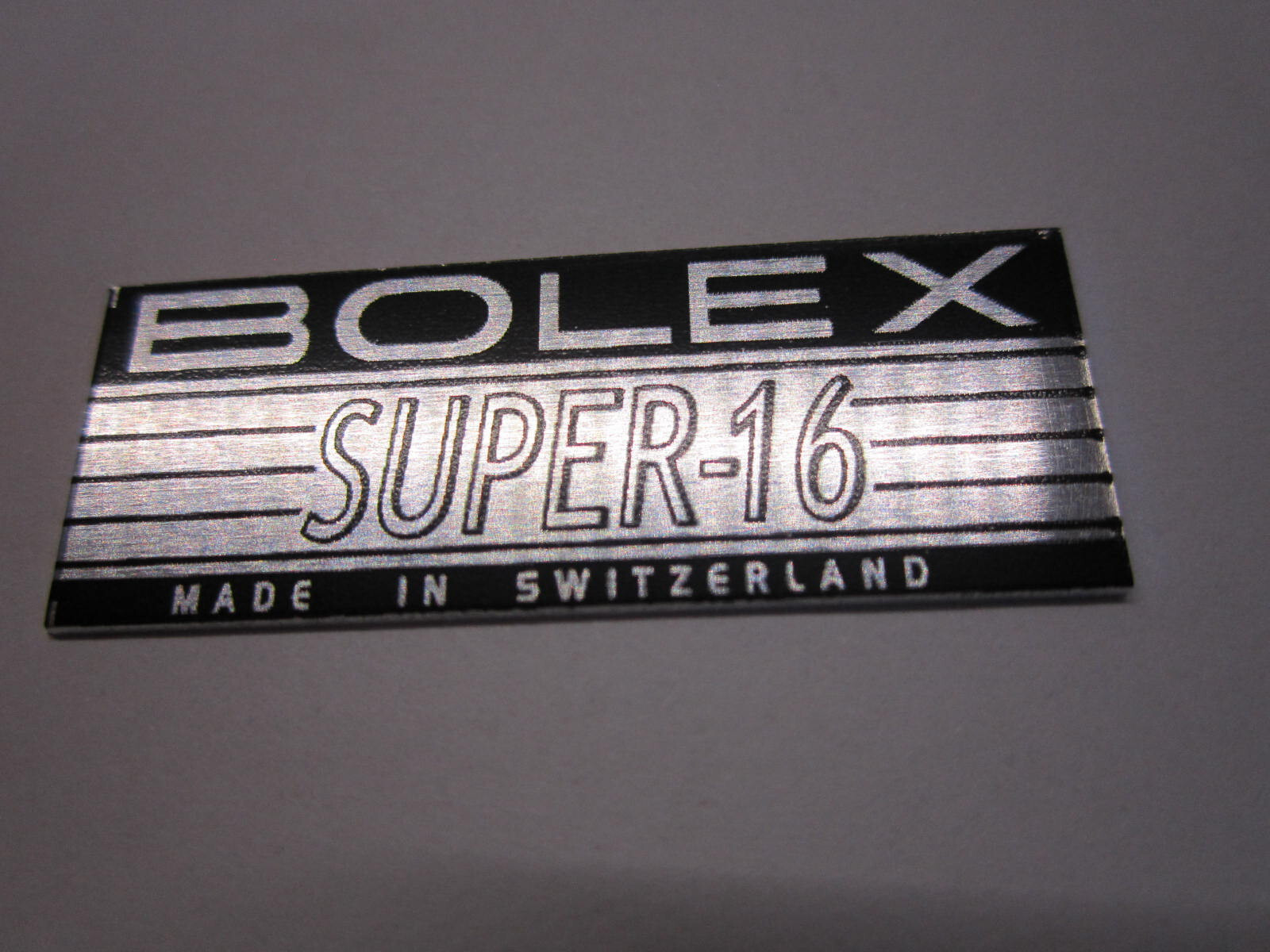 BOLEX ‘SUPER-16′ LOGO PLATE BADGE’ (Glue-In) for BOLEX H16 16mm movie camera