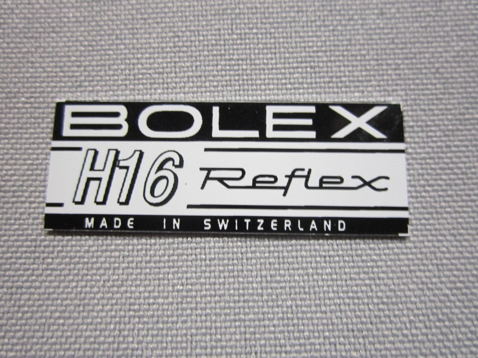 ‘BOLEX H16 REFLEX LOGO PLATE BADGE’ (Glue-In type) for BOLEX 16mm movie camera