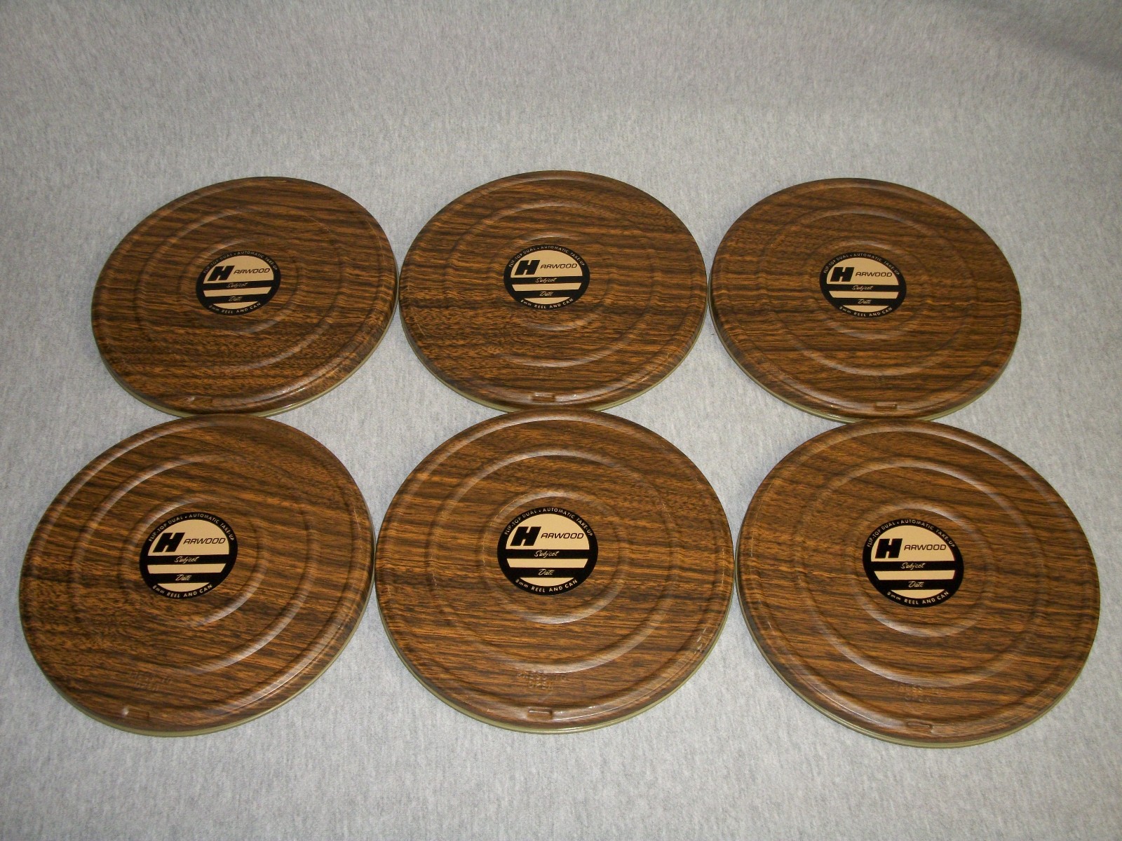 Lot of (6) Vintage 7″ Harwood 8mm Empty Movie Reels with Metal Cans & Metal Case