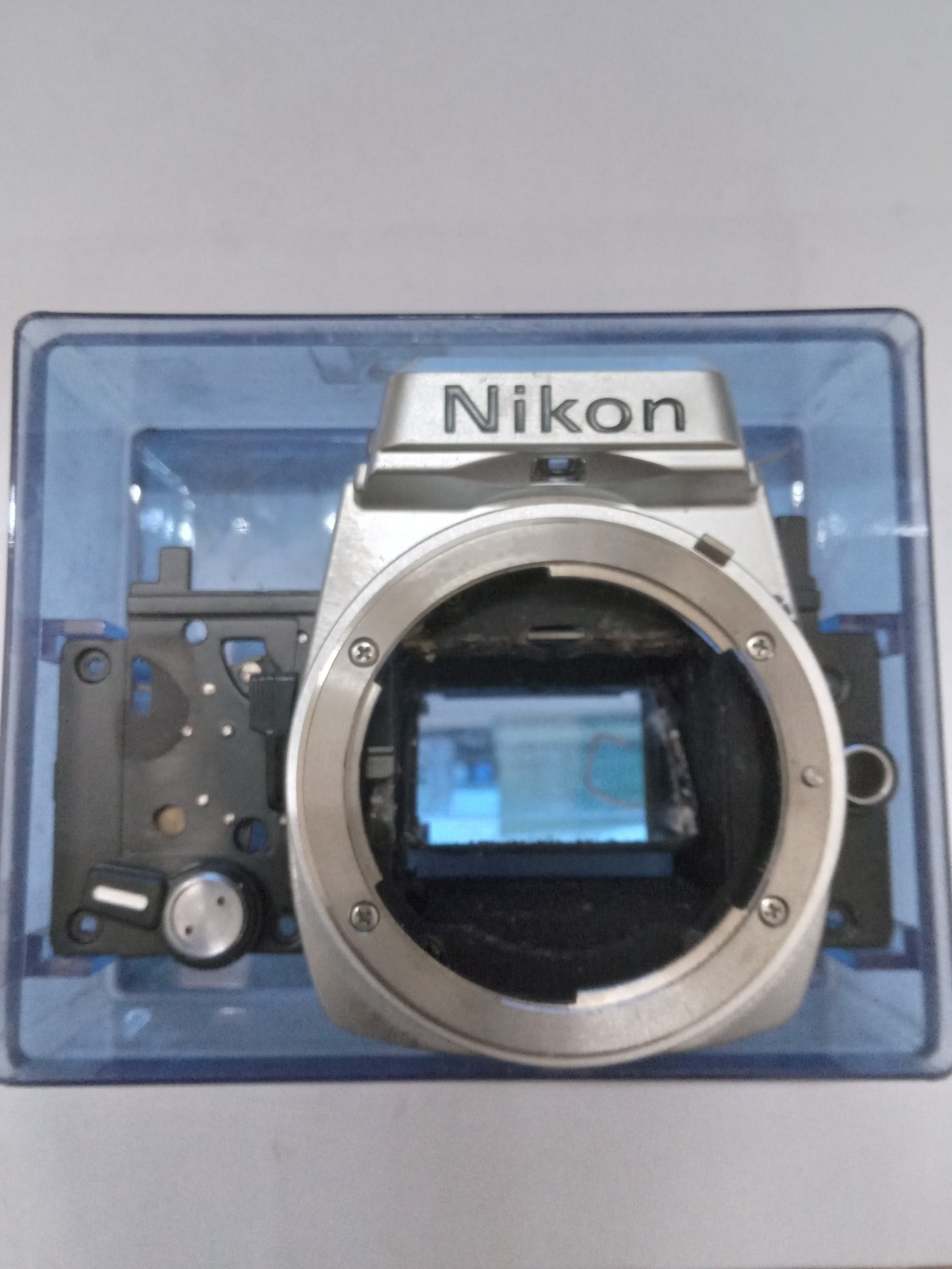 New Old Stock Silver / Chrome Nikon FE Front Bezel W Mirror Spare Part