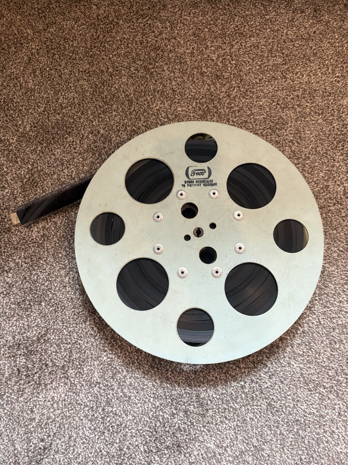 VINTAGE – 15 INCH REWIND FILM REEL – WITH MYSTERY FILM STILL ON – USED