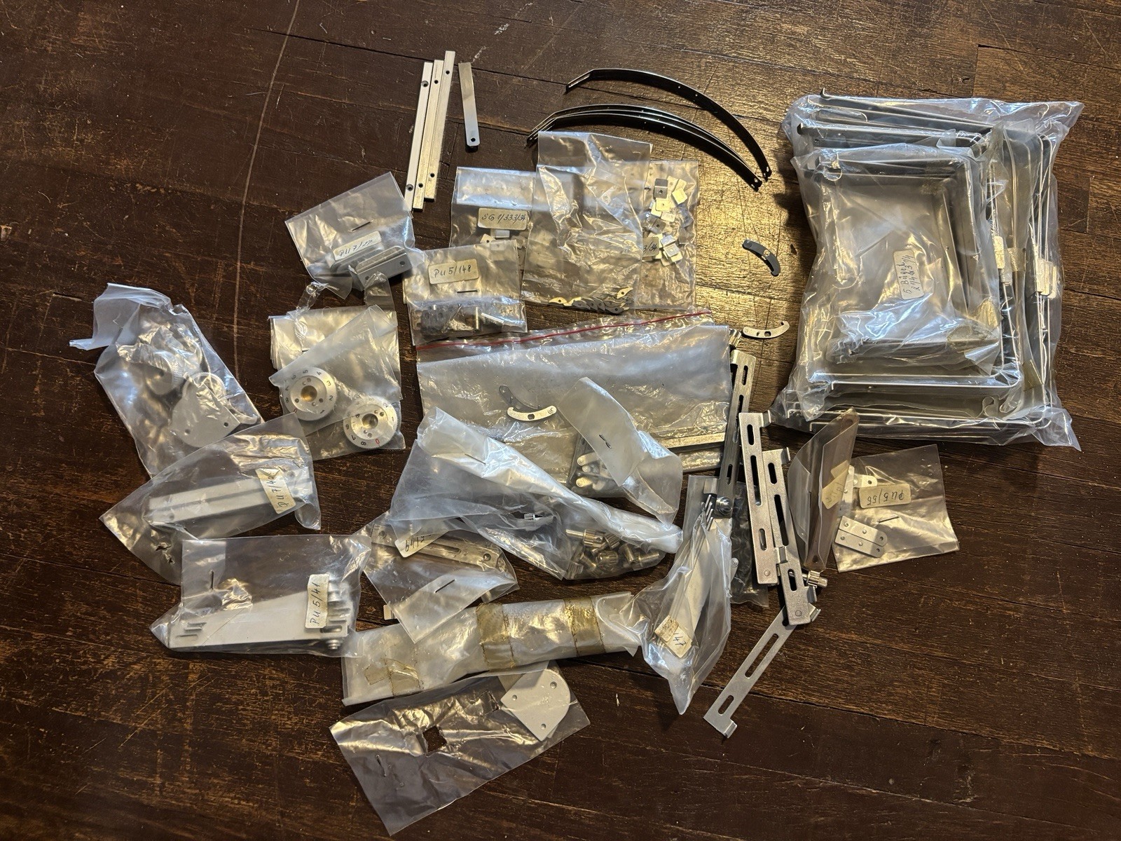 BOX OF BRAND NEW PARTS FOR PLAUBEL LARGE FORMAT CAMERAS