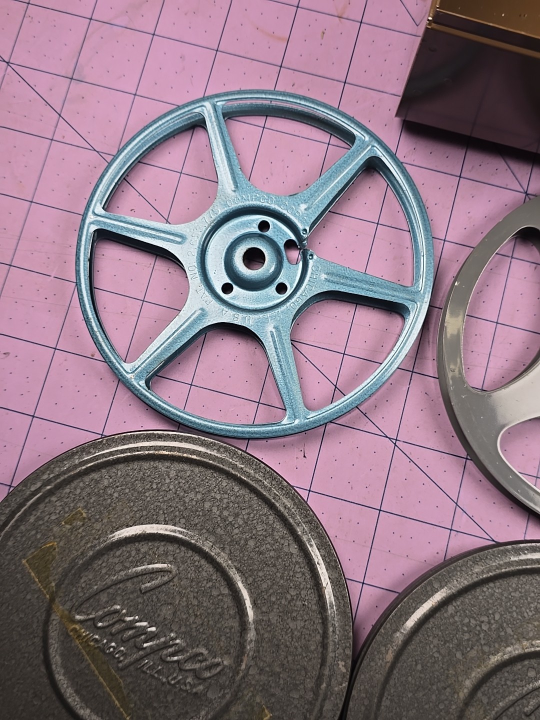3 – 5″ 200Ft movie reels, 2 cans and carrying case – Comco and Scherer
