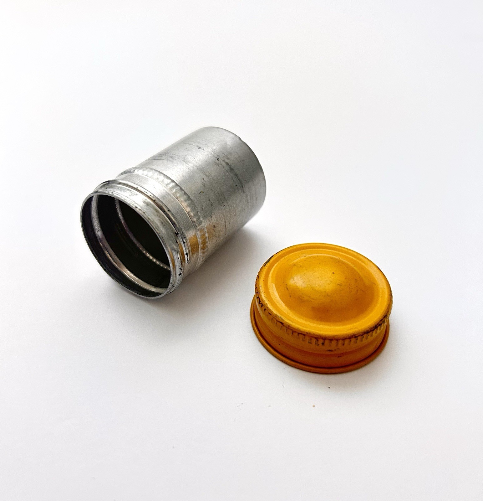 Classic Vintage 35mm aluminum film canister unbranded with metal yellow top cap