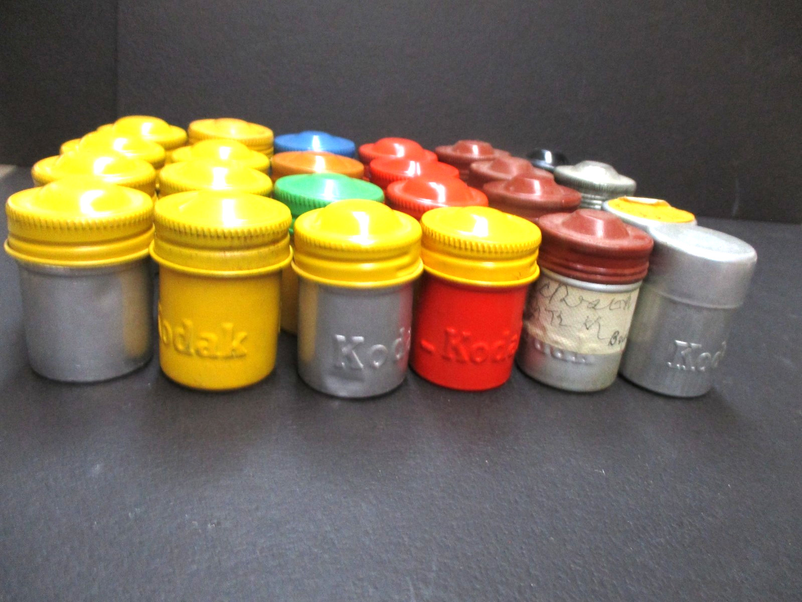 Lot 24 Kodak metal 35mm film canisters as shown.