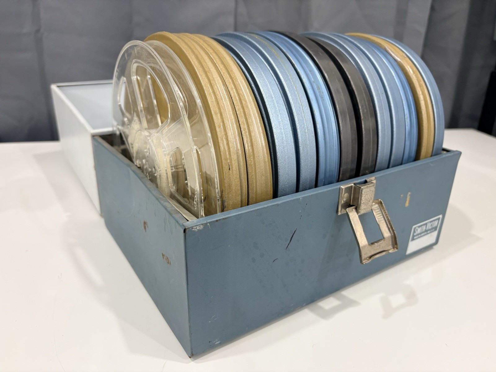 13 vintage 8mm film reels with 12 canisters and carrying case. No Film.