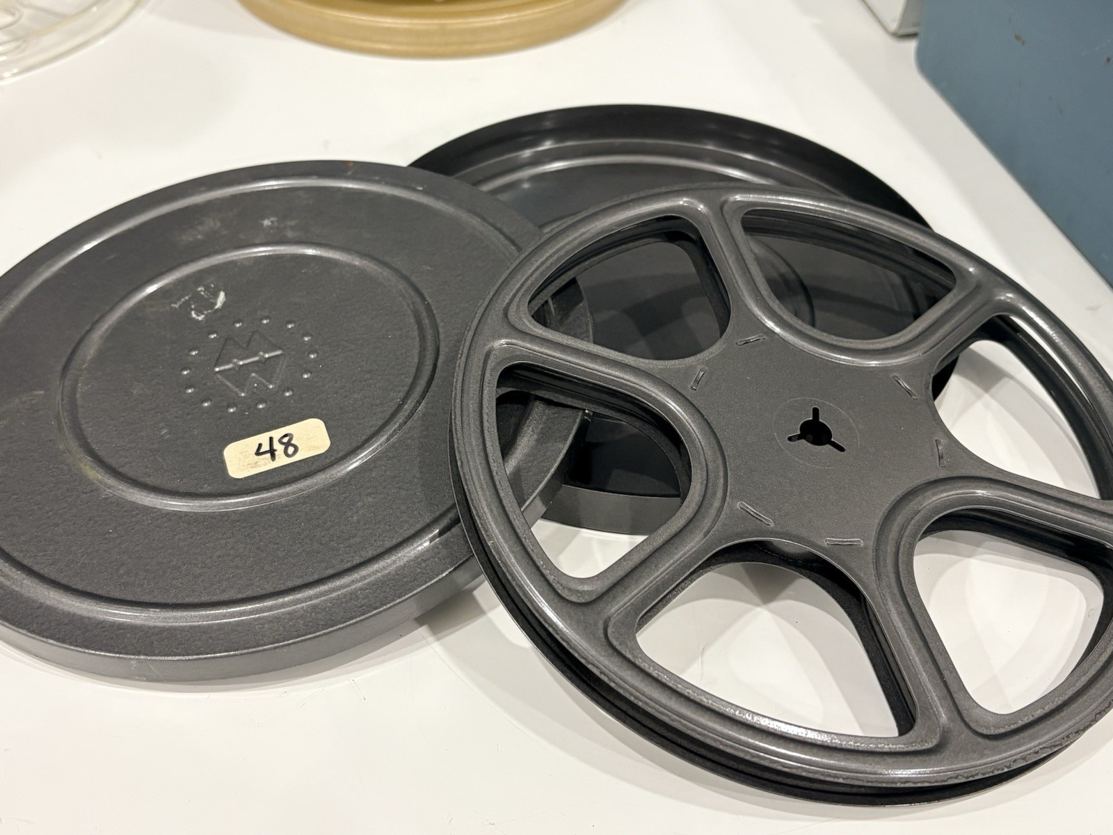 13 vintage 8mm film reels with 12 canisters and carrying case. No Film.