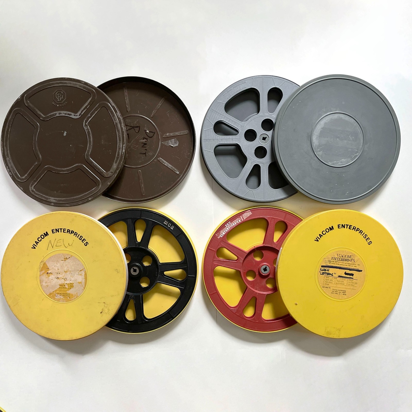 Assorted empty 1200′ 16mm Film Reels (3) and Canisters (4) incl. Fox / M*A*S*H