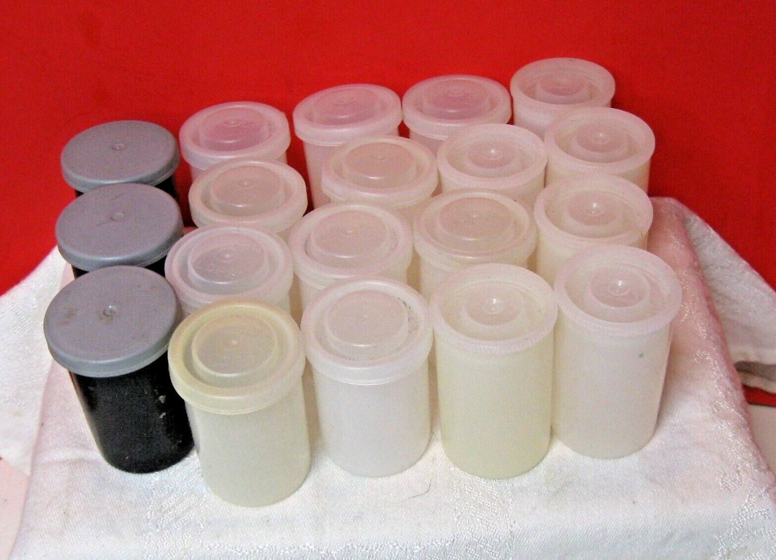 19 Film Cannisters; Five tall white, 12 shorter white, three grey.