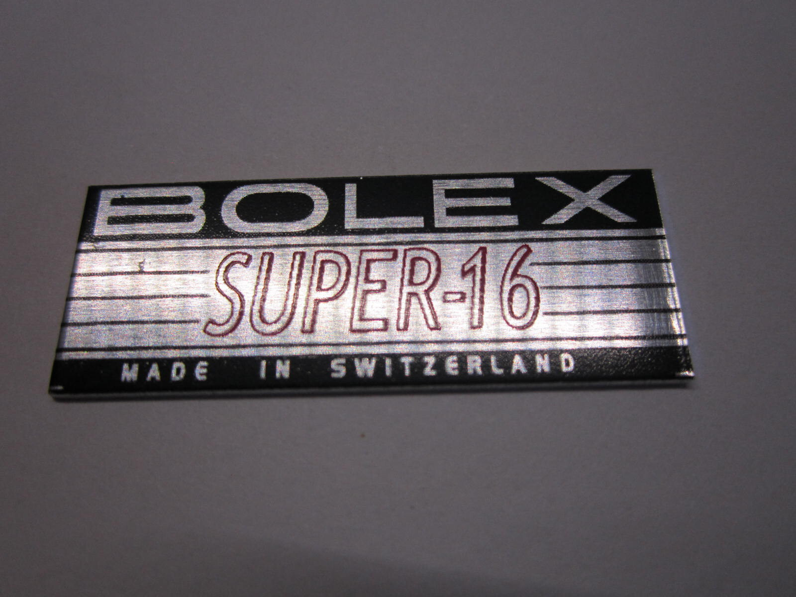 BOLEX RED ‘SUPER-16′ LOGO PLATE BADGE’ (Glue-In) for BOLEX 16mm movie camera