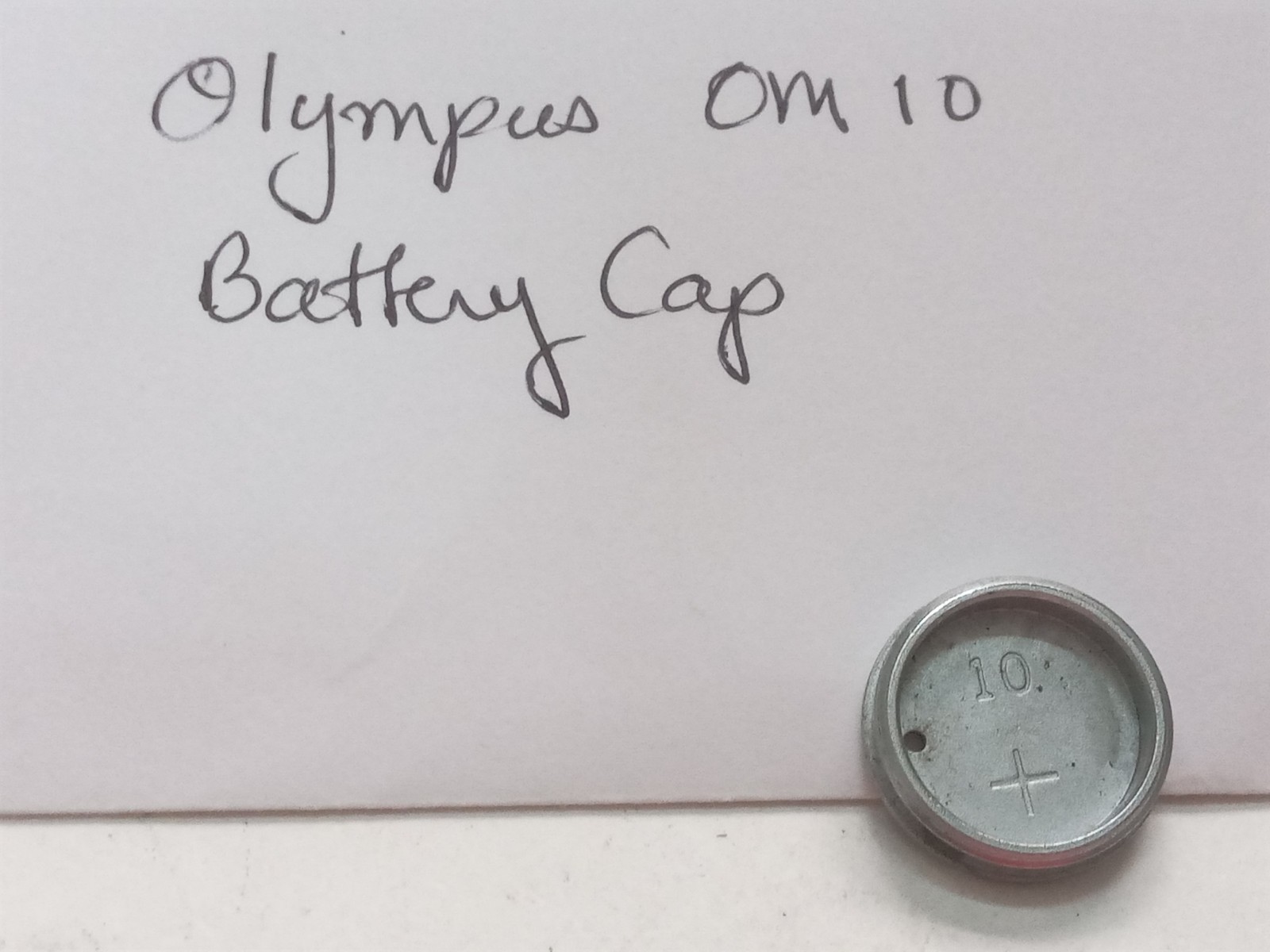 Olympus OM 10 Film SLR Camera Battery Cap Original Used Spare Part